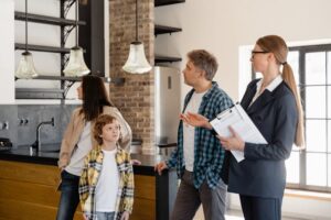 A family of three checks the house under the supervision of a real estate agent