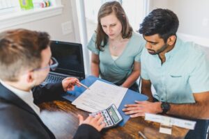 Financial advisor helping a couple decide between condo vs. house