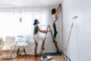 Couple painting walls 